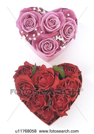 Stock Photo - Heart shape boxes with red and pink rose blossoms. Fotosearch