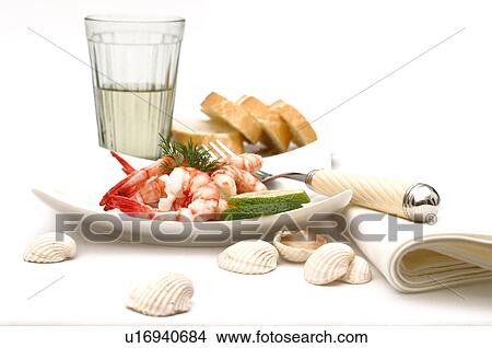 Picture - Dish of scampis and lime. Fotosearch