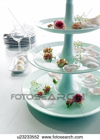 Stock Image - Etagere with rose blossoms and petals. Fotosearch