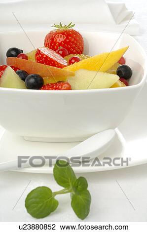 Stock Image - Fruit salad in a white porcelain bowl. Fotosearch