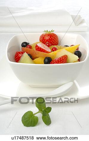 Stock Photo - Fruit salad in a white porcelain bowl. Fotosearch
