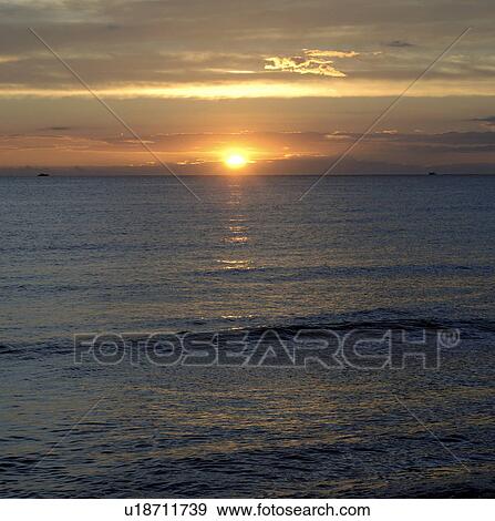 Stock Photo - Sunset at the sea. Fotosearch