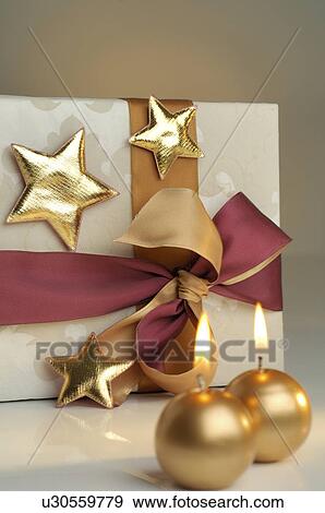 Christmas gift and golden candle View Large Photo Image Stock Photo - Christmas gift and golden candle. Fotosearch
