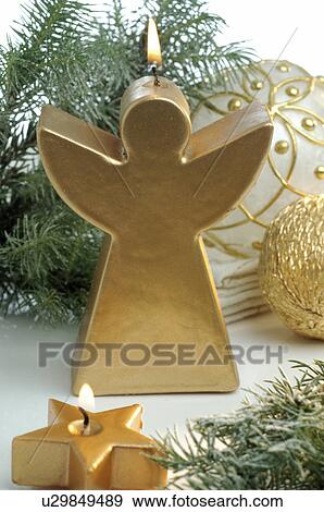 Stock Photo - Golden Christmas angel candle. Fotosearch
