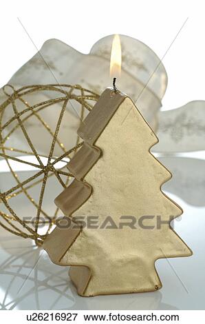 Golden Christmas tree shape candle View Large Photo Image Stock Photo - Golden Christmas tree shape candle. Fotosearch