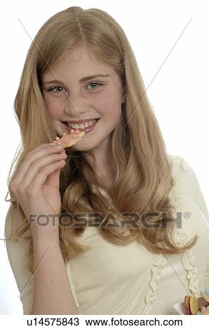 Woman eating Christmas biscuits View Large Photo Image Stock Image - Woman eating Christmas biscuits. Fotosearch