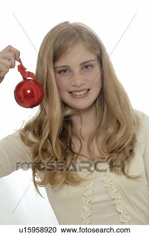 Woman holding a Christmas tree ball View Large Photo Image Stock Image - Woman holding a Christmas tree ball. Fotosearch