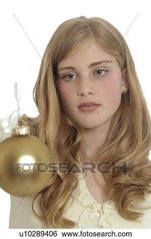 Stock Photograph - Woman holding a Christmas tree ball. Fotosearch