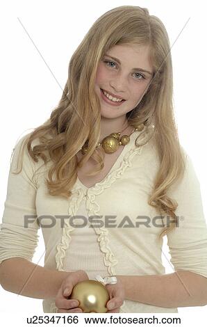 Stock Photograph - Woman holding a Christmas tree ball. Fotosearch