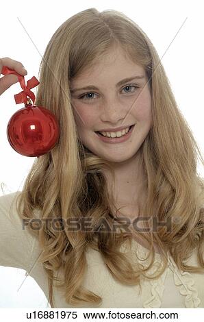 Stock Photography - Woman holding a Christmas tree ball. Fotosearch