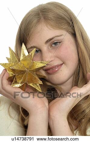 Woman holding a golden Christmas star View Large Photo Image Stock Image - Woman holding a golden Christmas star. Fotosearch