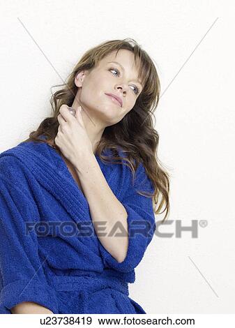 Woman in blue bathrobe with small bottle View Large Photo Image Stock Photo - Woman in blue bathrobe with small bottle. Fotosearch