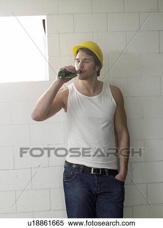 Construction worker is drinking beer View Large Photo Image Stock Photography - Construction worker is drinking beer. Fotosearch