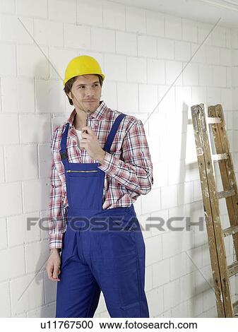 Construction worker wearing a helmet View Large Photo Image Stock Image - Construction worker wearing a helmet. Fotosearch