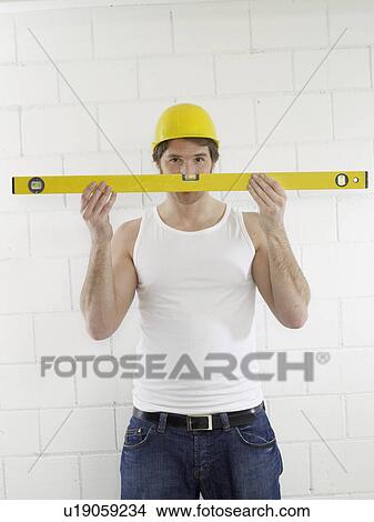 Construction worker with spirit level View Large Photo Image Picture - Construction worker with spirit level. Fotosearch