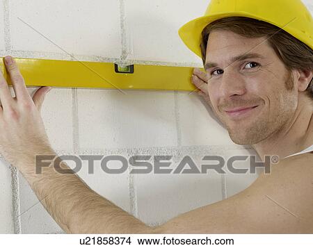 Picture - Construction worker with spirit level. Fotosearch