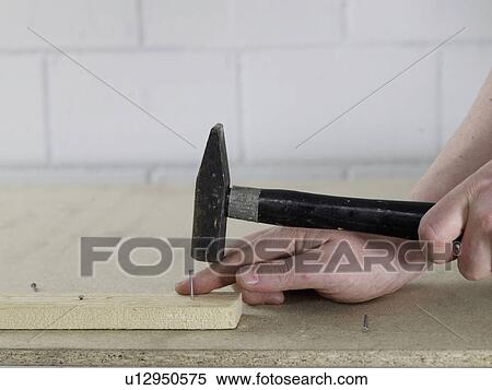 Stock Photography - Hammering a nail. Fotosearch