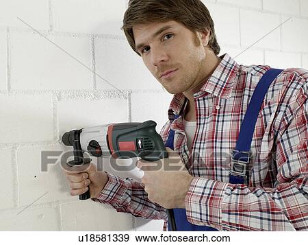 Man is using a drill View Large Photo Image Stock Photo - Man is using a drill. Fotosearch