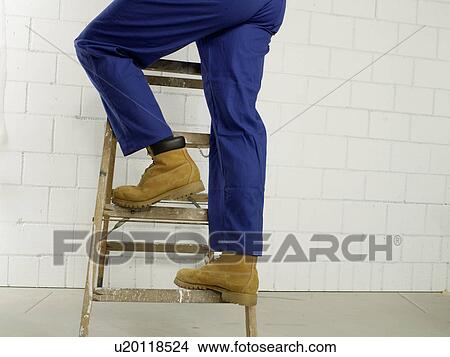 Picture - Man on a ladder, lower body. Fotosearch