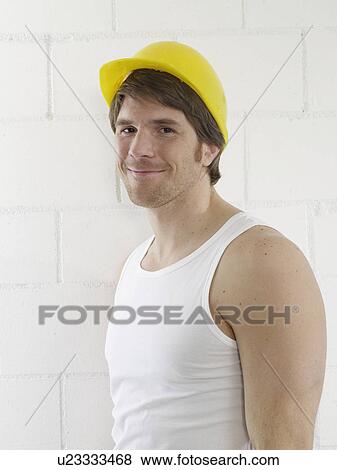 Stock Photo - Man wearing helmet and undershirt. Fotosearch