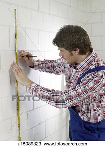 Man wearing work wear with pencil and folding rule View Large Photo Image Stock Image - Man wearing work wear with pencil and folding rule. Fotosearch