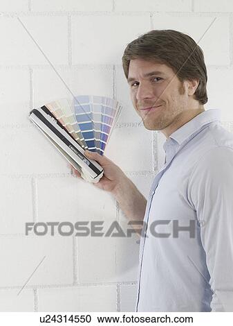 Stock Image - Man with colour palettes. Fotosearch