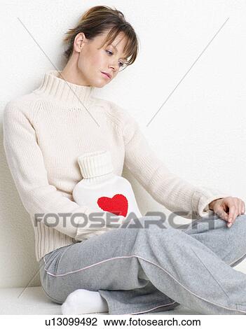 young woman with hot water bottle heart-style View Large Photo Image Stock Image - young woman with hot water bottle heart-style. Fotosearch