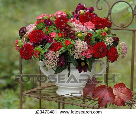 Stock Image - Bunch of Dahlias on an iron shelf. Fotosearch