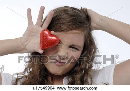 Young woman with a red chocolate heart View Large Photo Image Picture - Young woman with a red chocolate heart. Fotosearch