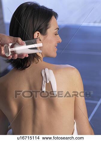 Sitting woman with body lotion on her back View Large Photo Image Picture - Sitting woman with body lotion on her back. Fotosearch