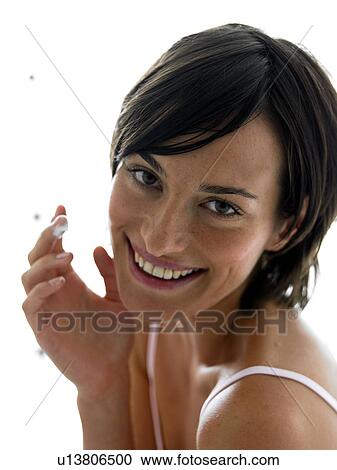 Stock Image - Woman in white tank top. Fotosearch