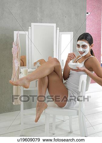 Stock Photo - Woman in white underwear with curd mask. Fotosearch