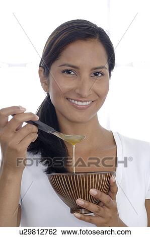 Stock Image - Woman with massage oil. Fotosearch