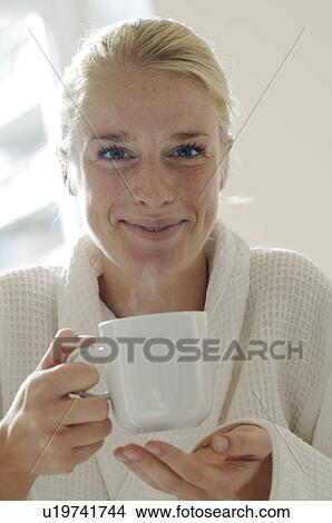 Young woman with dressing and coffee mug View Large Photo Image Picture - Young woman with dressing and coffee mug. Fotosearch