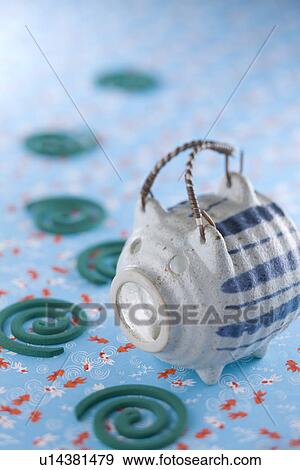 Stock Photo - Mosquito Coil and Pig-shaped Container. Fotosearch