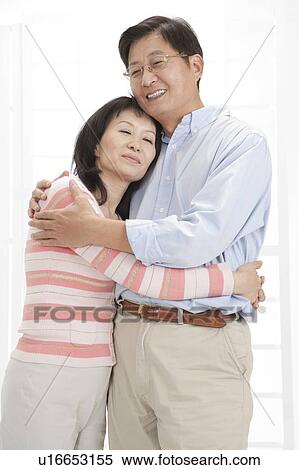 Stock Photography - Couple bonding together with eyes closed and smiling happily. Fotosearch