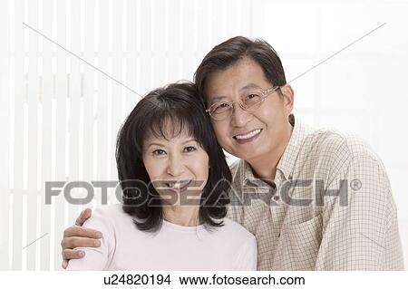Couple, Couple bonding together and looking at the camera with smile View Large Photo Image Picture - Couple, Couple bonding together and looking at the camera with smile. Fotosearch