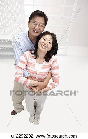 Couple, Couple bonding together and looking up with smile View Large Photo Image Stock Image - Couple, Couple bonding together and looking up with smile. Fotosearch