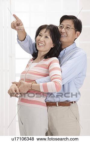 Stock Photo - Couple, Couple bonding together and looking up with smile. Fotosearch