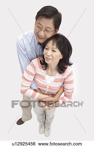 Stock Photograph - Couple, Couple bonding together and looking away with smile. Fotosearch
