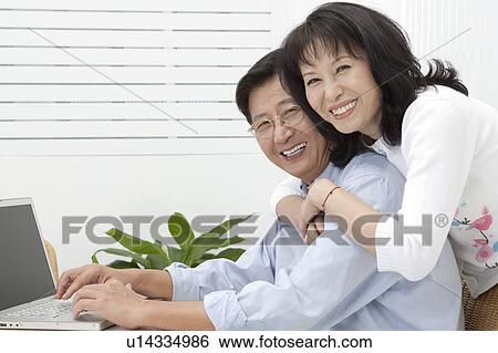 Couple, Couple bonding together and smiling at the camera View Large Photo Image Stock Photograph - Couple, Couple bonding together and smiling at the camera. Fotosearch