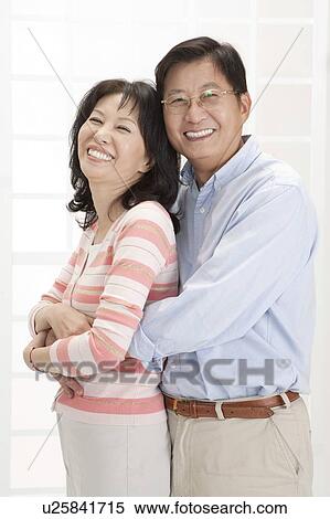 Stock Photography - Couple, Couple bonding together and smiling at the camera. Fotosearch