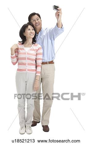 Couple, Couple standing together and taking pictures with smile View Large Photo Image Stock Image - Couple, Couple standing together and taking pictures with smile. Fotosearch