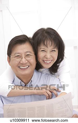 Couple, Wife bonding husband with arms around and smiling happily View Large Photo Image Stock Image - Couple, Wife bonding husband with arms around and smiling happily. Fotosearch