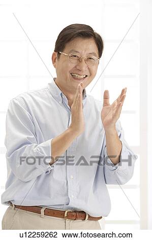 Stock Image - Husband, Man clapping and smiling happily. Fotosearch