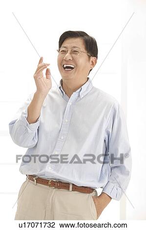 Husband, Man standing with hands in pocket and laughing View Large Photo Image Stock Image - Husband, Man standing with hands in pocket and laughing. Fotosearch
