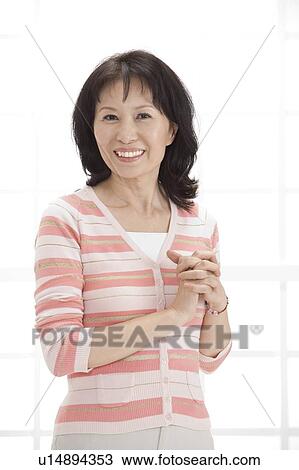 Wife, Woman holding hands and smiling at the camera View Large Photo Image Stock Image - Wife, Woman holding hands and smiling at the camera. Fotosearch
