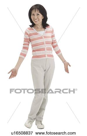 Wife, Woman standing with a pose and smiling View Large Photo Image Stock Photo - Wife, Woman standing with a pose and smiling. Fotosearch