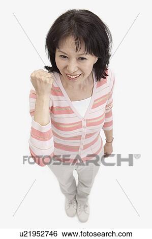 Stock Photograph - Wife, Woman standing with arms raised and smiling with confidence. Fotosearch