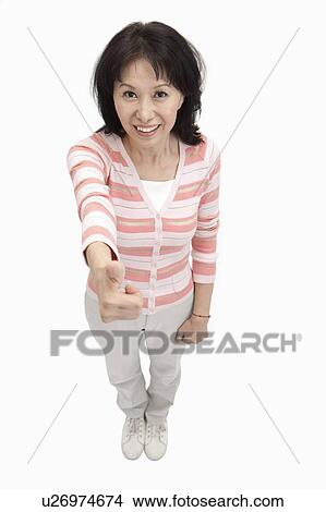 Picture - Wife, Woman standing with thumbs up and looking up with smile. Fotosearch